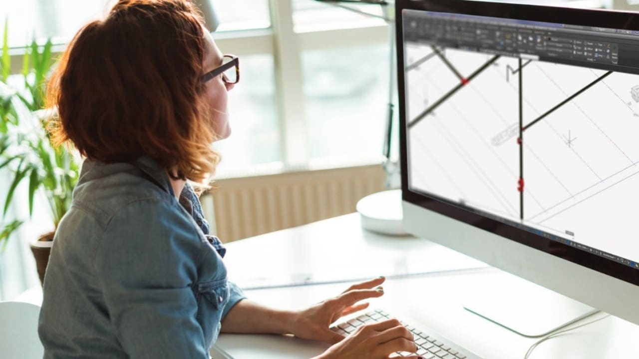 Photo of a woman using technical design software on a computer
